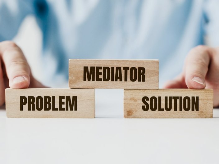 Wooden blocks reading Problem, Mediator, and Solution — representing AXIS's structured approach to dispute resolution